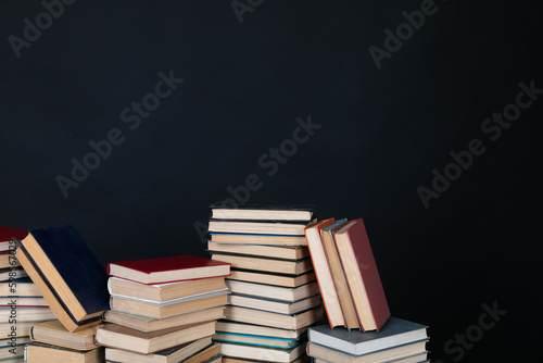 stacks of books scientific literature knowledge in the library on a black background