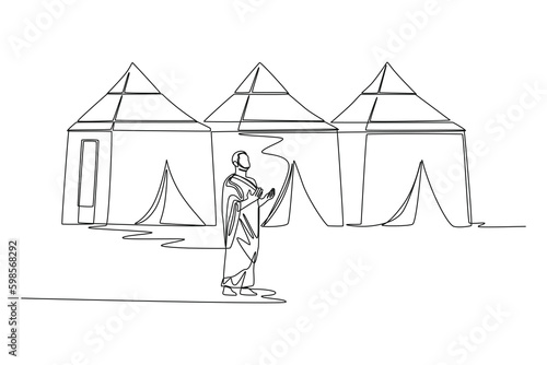 Continuous one line drawing a Muslim with his Ihram dress doing wukuf in Arafah. Hajj and umrah concept. Single line draw design vector graphic illustration.