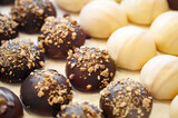 Round cakes with white and dark chocolate and nuts, selective focus
