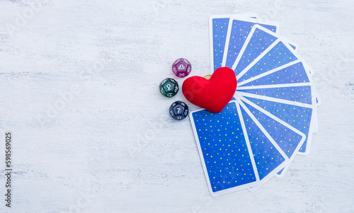 Dice divination with tarot card and red heart with space on wood background, astrology dice fortune telling divination tools, love life prediction
