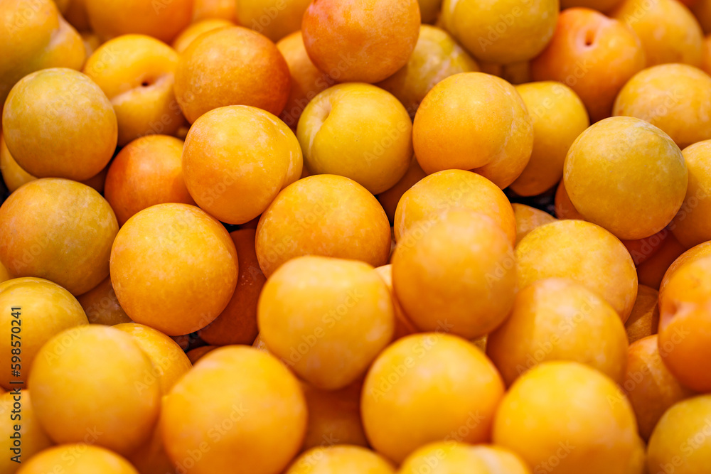 Plums yellow raw in bulk on supermarket, selective focus Plums yellow raw in bulk on supermarket, selective focus