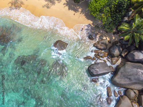 Aerial view of Glacis Beach with palm trees and rocks photo