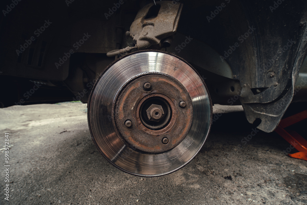 Old Disk brake and car service concept - Vehicle brake pad replacement service by hand of mechanic man in car, do it yourself, myself. Old Disk brake and car service concept - Vehicle brake pad replacement service by hand of mechanic man in car, do it yourself, myself.