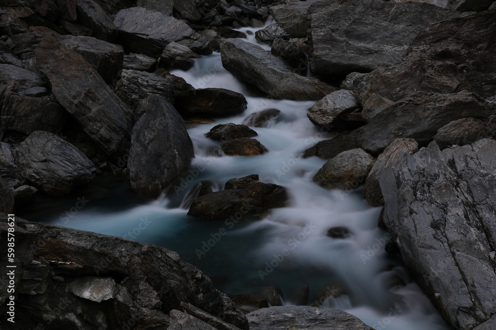 Stream of a river flowing through the rocks Stream of a river flowing through the rocks