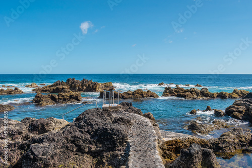 Stone pathway in volcanic rock in the natural sea pools in Biscoitos on the island of Terceira, Azores PORTUGAL photo