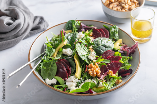 Healthy Salad made from Green Salad Leaves, Rocket Salad, Slices of Beetroot, Avocado, pieces of Feta Cheese, Walnuts and Sesame Seeds.