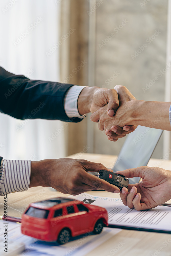 The salesman shakes hands with the customer, after signing the contract and completing the payment, the sales manager offers to sell the car and explain the insurance terms in the office.