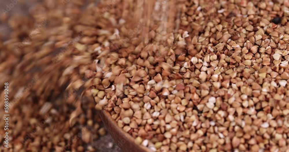 a large amount of low-quality processing of buckwheat groats close-up, Poorly cleaned buckwheat groats for cooking porridge a large amount of low-quality processing of buckwheat groats close-up, Poorly cleaned buckwheat groats for cooking porridge
