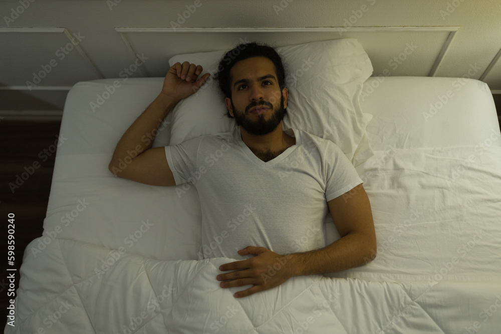 Fototapeta premium Top view of a latin man suffering from insomnia