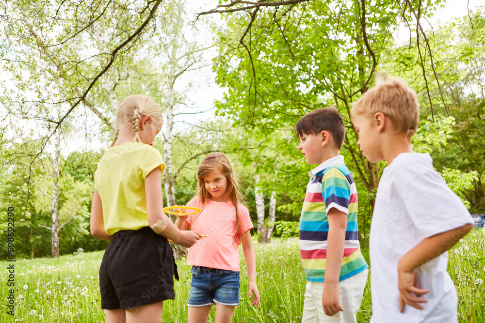 Obraz premium Children playing with bubble wand in garden