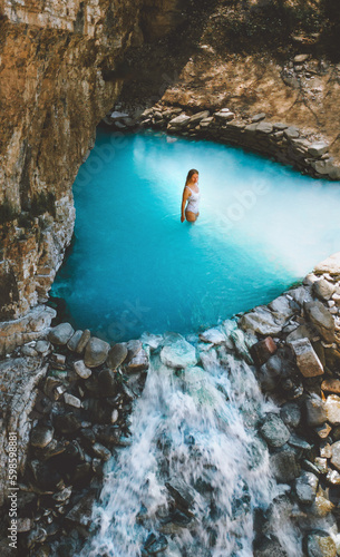 Woman relaxing in thermal bath traveling in Albania girl bathes in hot spring summer vacations healthy lifestyle healing blue water