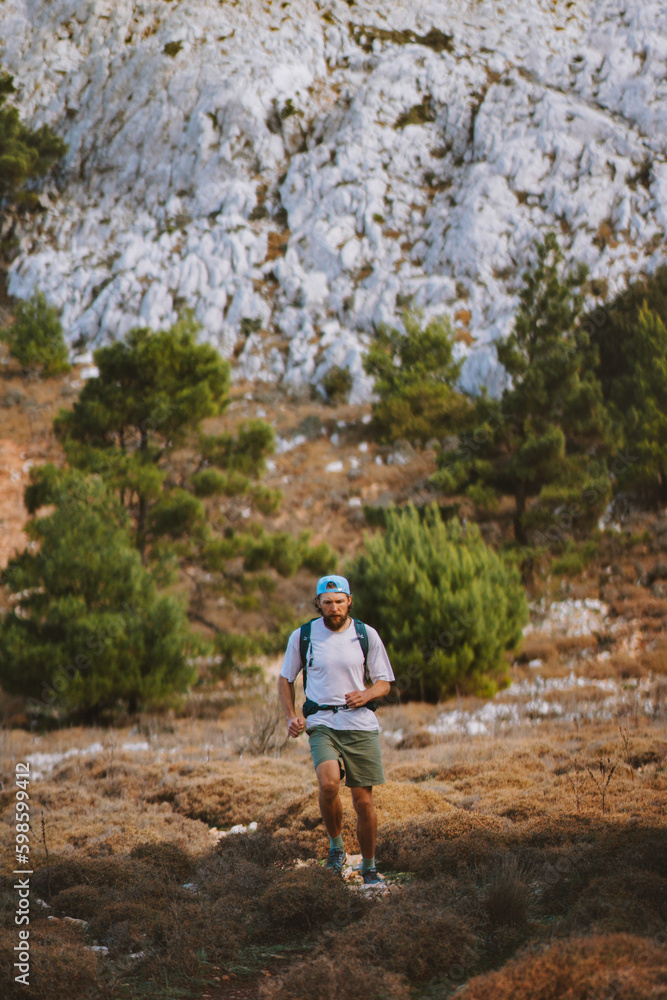 Man trail running in mountains travel hiking adventure active outdoor summer vacations healthy lifestyle motivation sport concept Man trail running in mountains travel hiking adventure active outdoor summer vacations healthy lifestyle motivation sport concept
