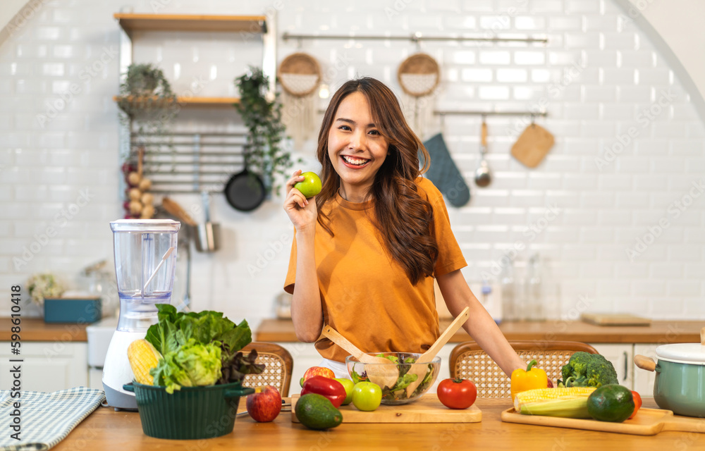 Portrait of beauty body slim healthy asian woman having fun cooking and preparing vegan food healthy eat with fresh vegetable salad, apple in kitchen at home.Diet concept.Fitness and healthy food Portrait of beauty body slim healthy asian woman having fun cooking and preparing vegan food healthy eat with fresh vegetable salad, apple in kitchen at home.Diet concept.Fitness and healthy food