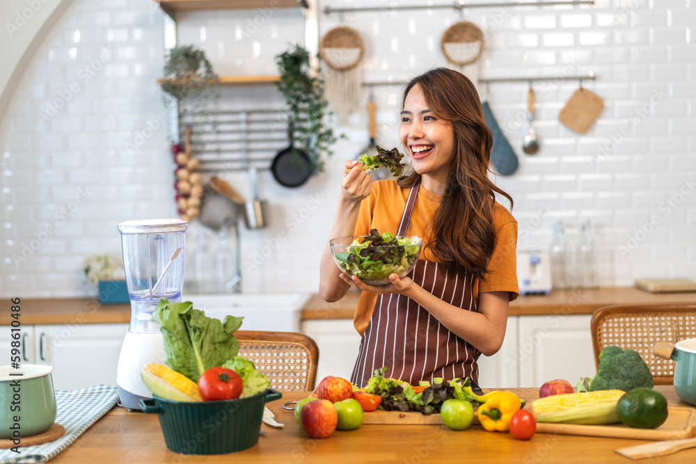 Portrait of beauty body slim healthy asian woman having fun cooking and preparing cooking vegan food healthy eat with fresh vegetable salad on counter in kitchen at home.Diet concept.Fitness, healthy Portrait of beauty body slim healthy asian woman having fun cooking and preparing cooking vegan food healthy eat with fresh vegetable salad on counter in kitchen at home.Diet concept.Fitness, healthy