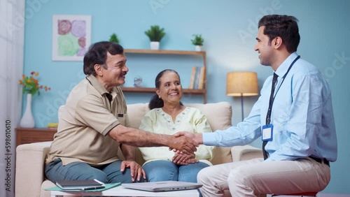 Indian banking officer greeting by hand shaking to senior couple at home - concept of financial advisor, expert consultation and professional occupation