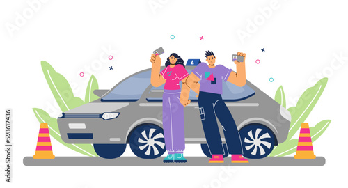 Happy young boy and girl standing near training car and holding driver licenses