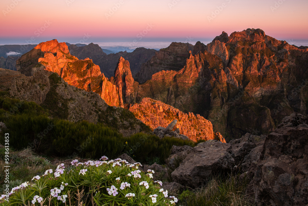 Sunrise in Madeira mountains peaks in sunlight, scenic view over landscape and Pico Ruivo, Portugal