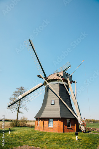 Windmill with red brick. Mill in Germany in the countryside. Rural area in Northern Germany