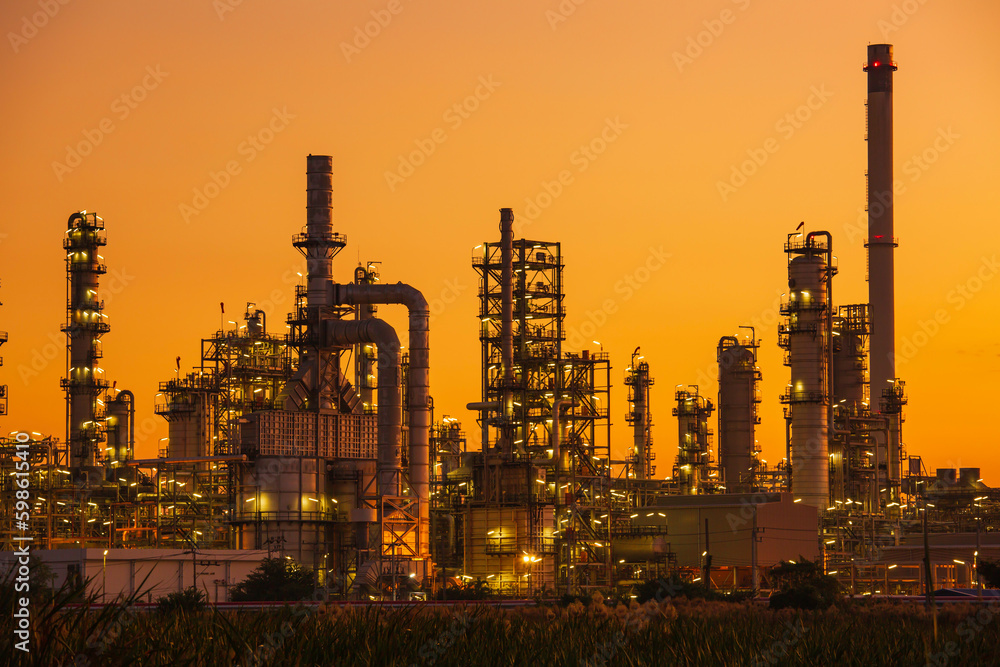 Oil​ refinery​ and​  plant and tower column of Petrochemistry industry in oil​ and​ gas​ ​industrial with​ cloud​ orange​ ​sky