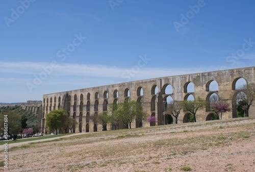 Elvas, Portugal - March 30, 2023: Wonderful landscapes in Portugal. Beautiful scenery of Amoreira Aqueduct in Elvas. 16th-century aqueduct. It brings water into the fortified seat. Selective focus photo