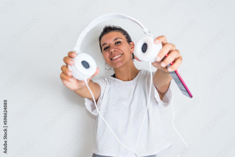 young latina woman with white headphones in her hands young latina woman with white headphones in her hands