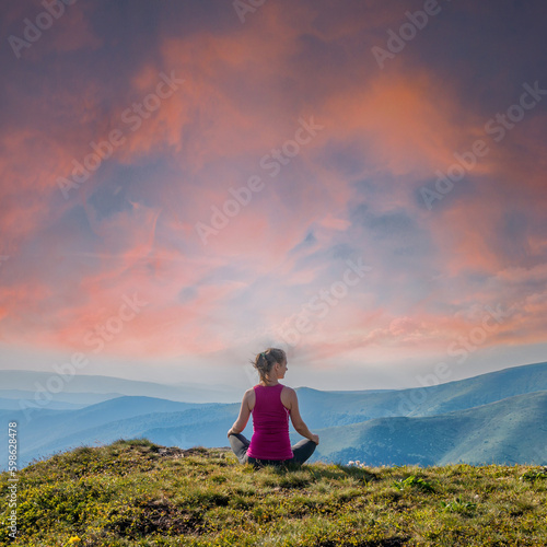 Young woman on the top of mountain