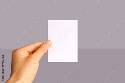 Realistic hand holding A7 paper mockup. Portrait A7 international paper size mockup. Simple, clean, modern, minimal paper mock up. Paper mockup in hand