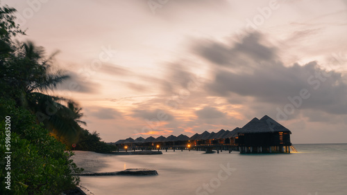 water villas with a dramatic sky in the background