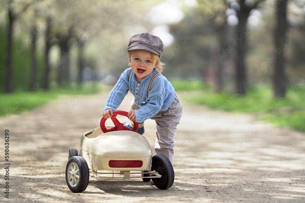 happy smiling boy is starting with his toy car happy smiling boy is starting with his toy car