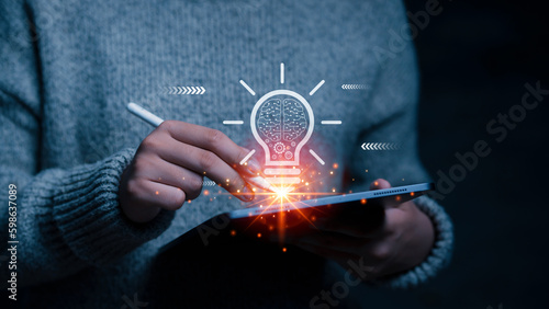 User using smart tablet and light bulb with digital technology working idea icon , business of a new idea and success concept. development business creative processes.