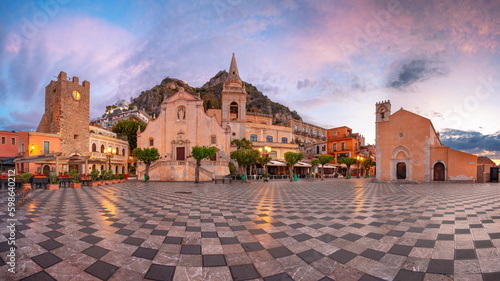 Taormina, Sicily, Italy. Panoramic cityscape image of picturesque town of Taormina, Sicily with main square Piazza IX Aprile and San Giuseppe church at sunrise.
