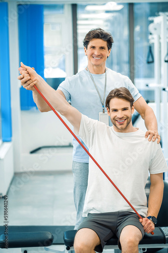 Young man having a physical therapy session with a doctor