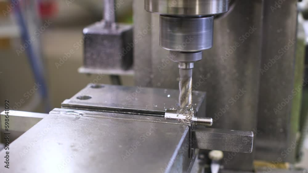 The work of production machines at the factory. Pan around the process of milling metal plates on a CNC milling machine. Milling shop on a milling machine The work of production machines at the factory. Pan around the process of milling metal plates on a CNC milling machine. Milling shop on a milling machine
