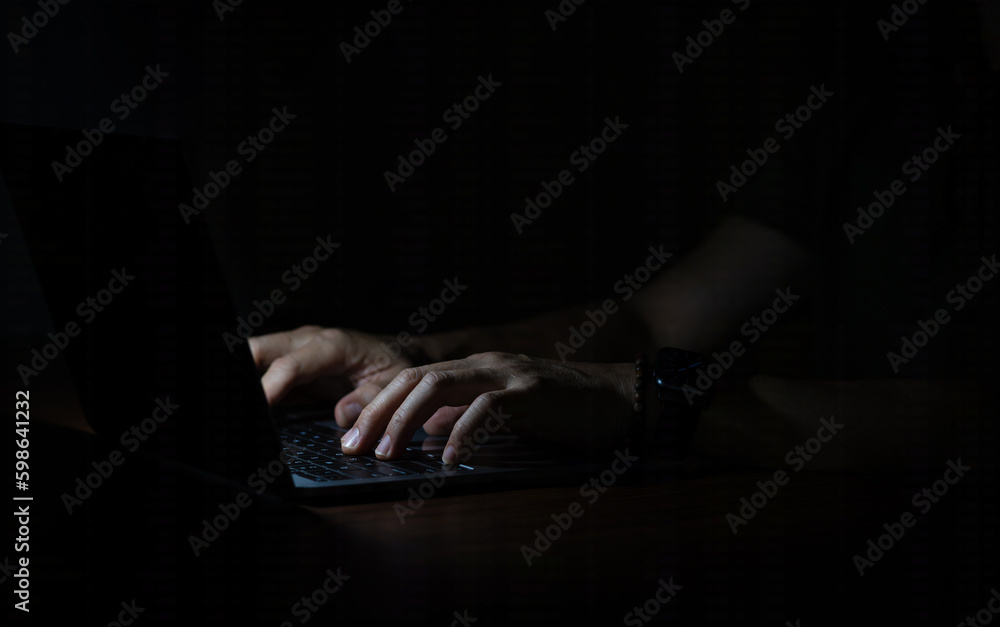 Close up of hands typing and using laptop in the dark. Close up of hands typing and using laptop in the dark.