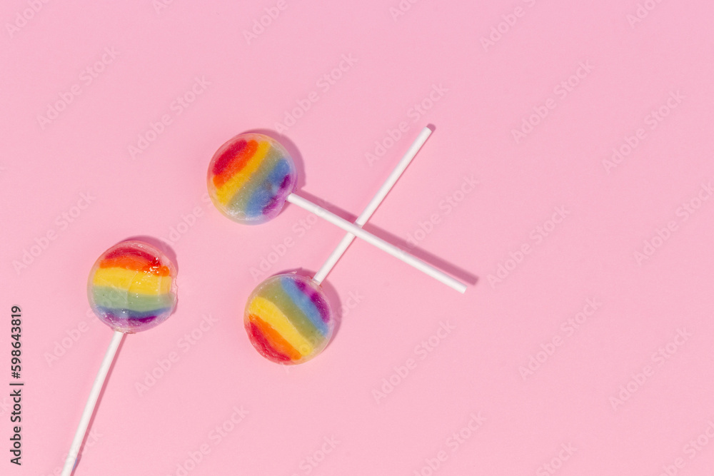 Top view of rainbow lollipop on pink background Top view of rainbow lollipop on pink background