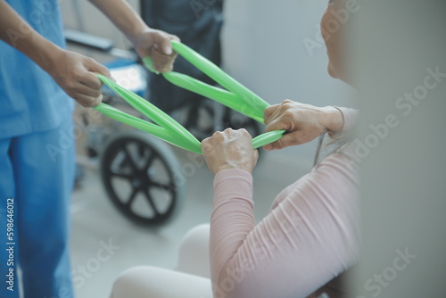 young asian physical therapist working with senior woman on walking with a walker