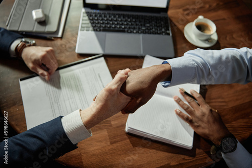 Fotografi High angle view of business people shaking hands to conclude a deal during busin