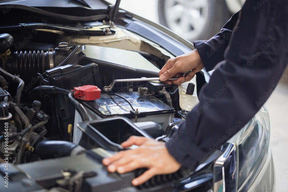 Naklejka premium Auto mechanic working in garage, Technician checking modern car at garage, Car repair and maintenance concepts