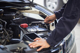 Auto mechanic working in garage, Technician checking modern car at garage, Car repair and maintenance concepts
