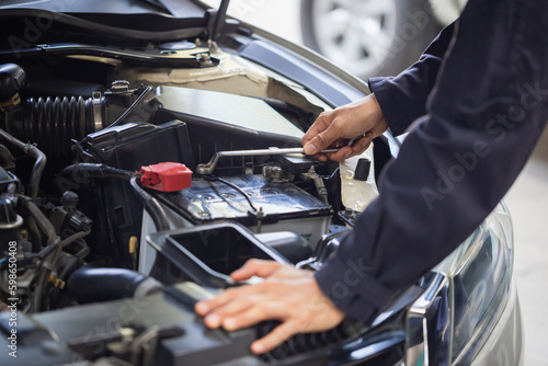 Auto mechanic working in garage, Technician checking modern car at garage, Car repair and maintenance concepts