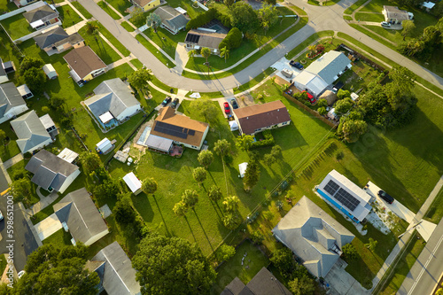 Aerial landscape view of suburban private houses between green palm trees in Florida quiet rural area