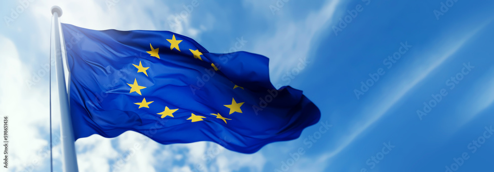 european union flag waving in the wind on flagpole against blue sky ...