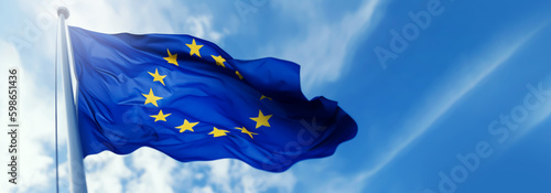 Canvas Print european union flag waving in the wind on flagpole against blue sky