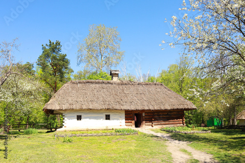 Whitewashed house with a thatched roof from Middle Transnistria in skansen Pirogovo in Kyiv, Ukraine