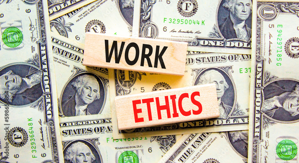 Work ethics symbol. Concept words Work ethics on beautiful wooden block. Beautiful background from dollar bills. Business and Work ethics concept. Copy space.