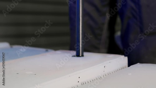 A manufacturing worker adds paint to a silicone mold to paint the manufactured plastic part inside