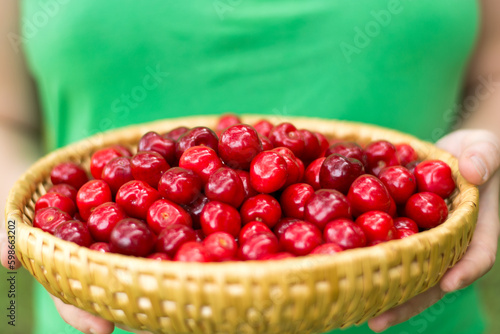 holding a bowl of cherries