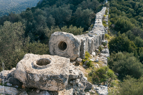 Ruins of old Roman Aqueduct. View Delikkemer Bridge at olive forest near Mediterranean sea coast. Near to Patara Ancient City at location Kalkan, Kas, Antalya. Popular travel destination in Turkey