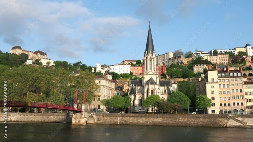 Saint Georges church and pedestrian bridge with Saone river flowing in Lyon France, sunny morning in spring Saint Georges church and pedestrian bridge with Saone river flowing in Lyon France, sunny morning in spring