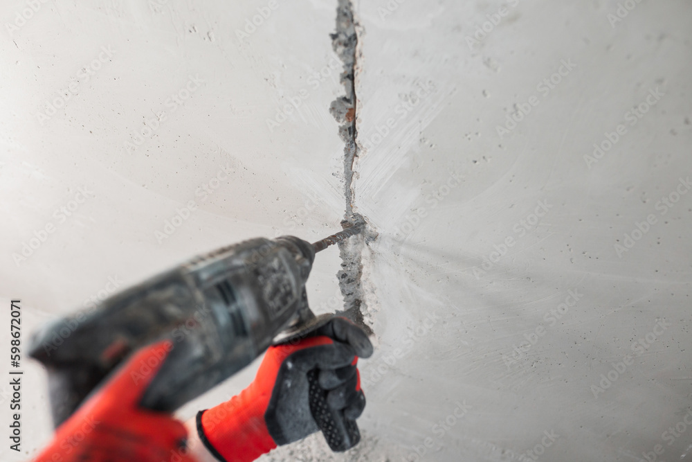 Installation of electrical outlets in a concrete wall hidden electrical wiring at a house